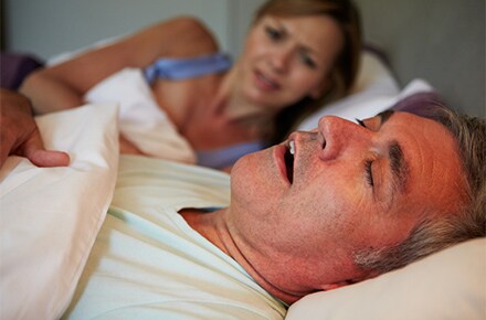 snoring man woman annoyed