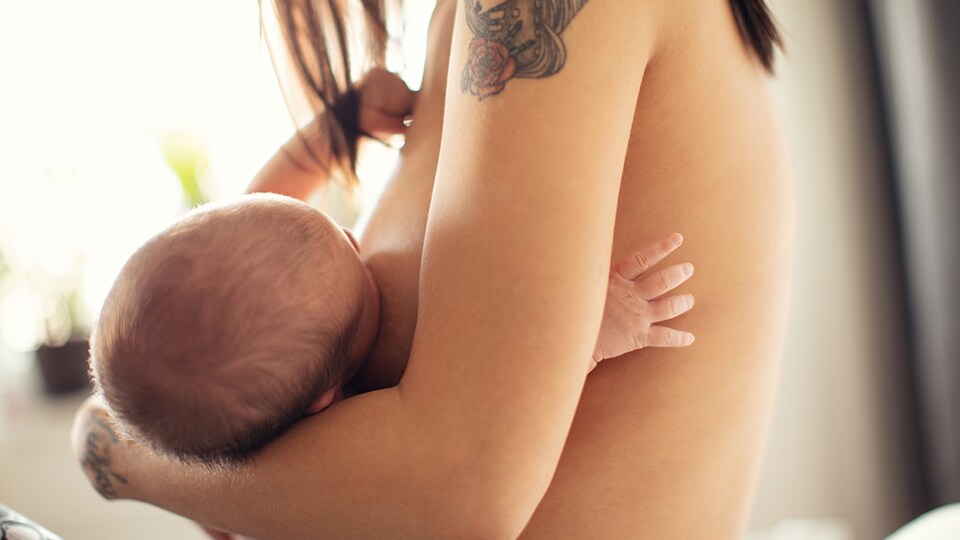 Mother breastfeeding newborn