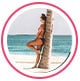 Profile image of reviewer, a woman in a bikini leaning against a palm tree on the beach.