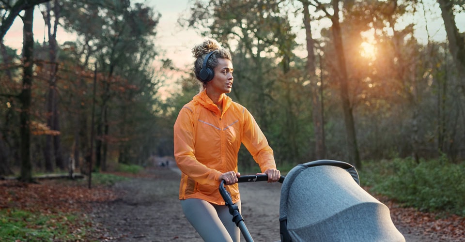 Athlete using on-ear headphones during a walk