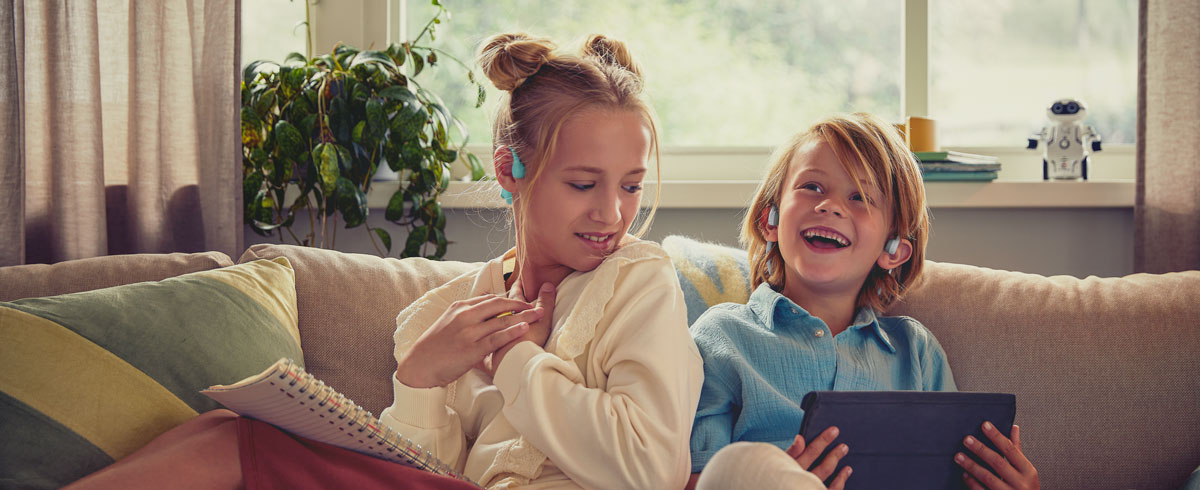 Kids enjoying a video using Philips kids open-ear headphones