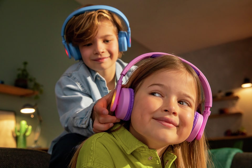 Two siblings playing while using on ear Kids Headphones