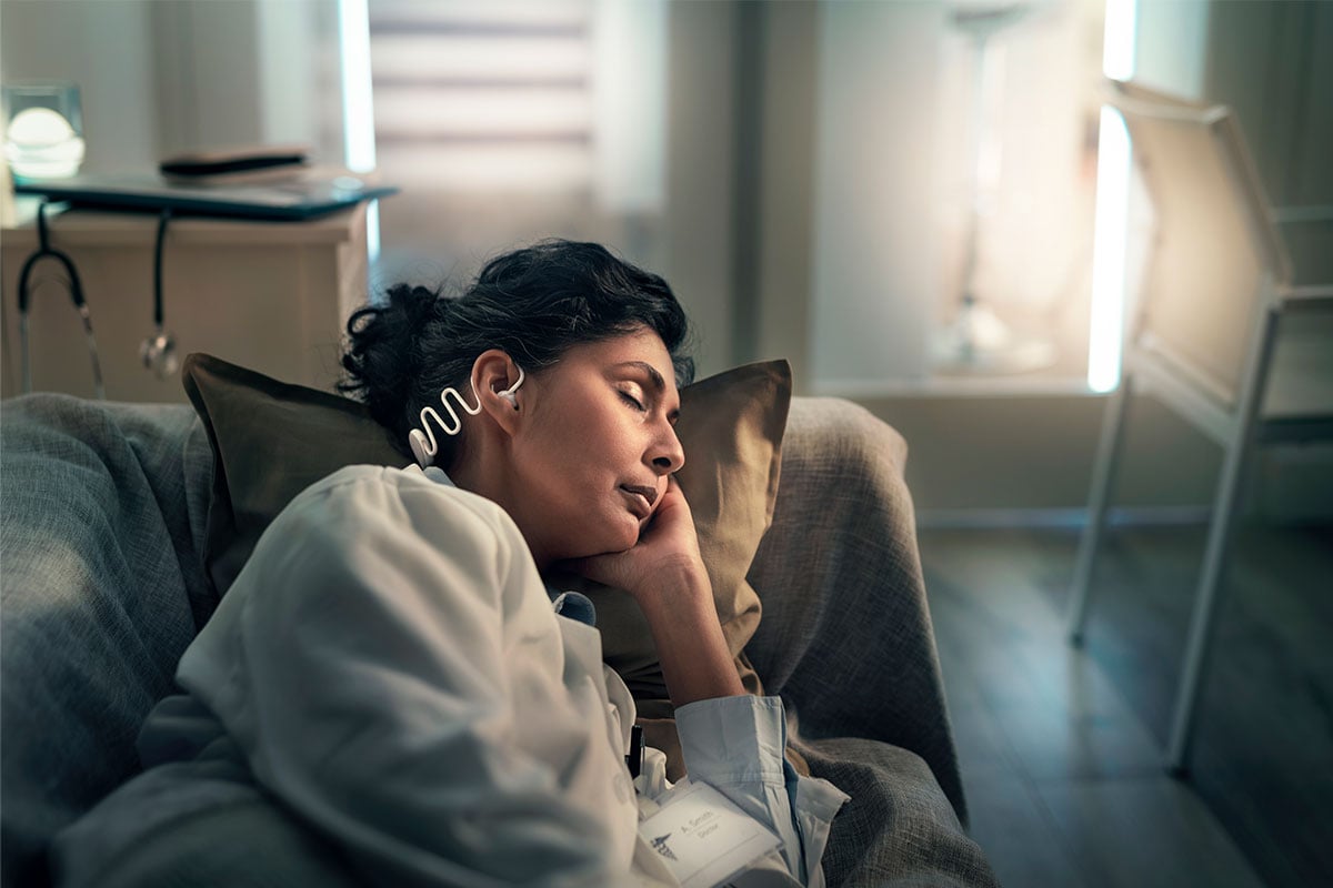 Woman wearing Philips Sleep Headphones comfortably while sleeping on her side