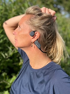 Woman wearing Philips bone conduction bluetooth headphones