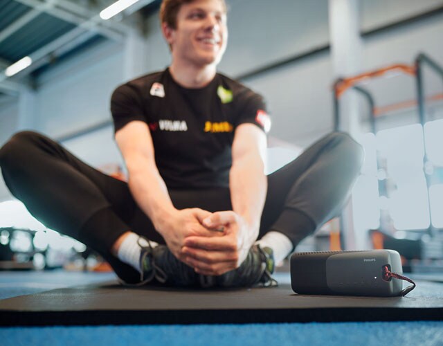 Man excersising while using wireless speakers