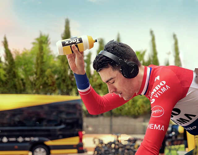 Man cycling with on ear wireless sports headphones