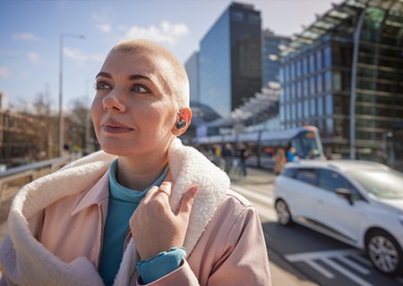 Woman enjoying outside using Philips T3508 true wireless headphones
