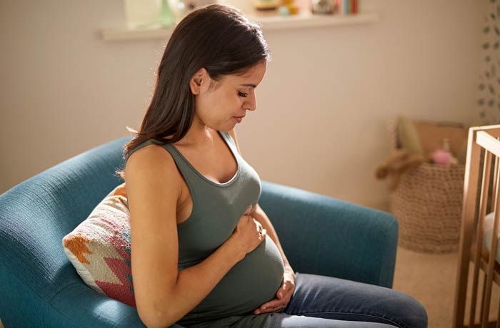 Picture of pregnant woman caressing her baby bump