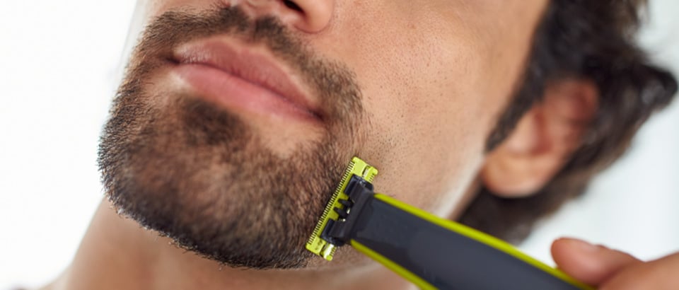 Man trimming stubble with Philips Oneblade