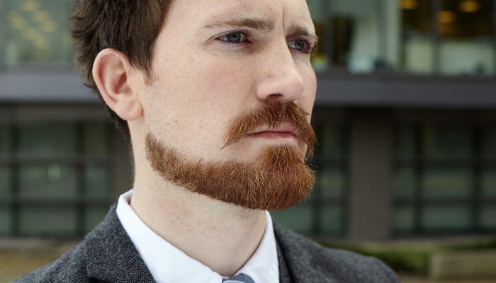 Close-up of a man with a precisely trimmed Balbo beard.