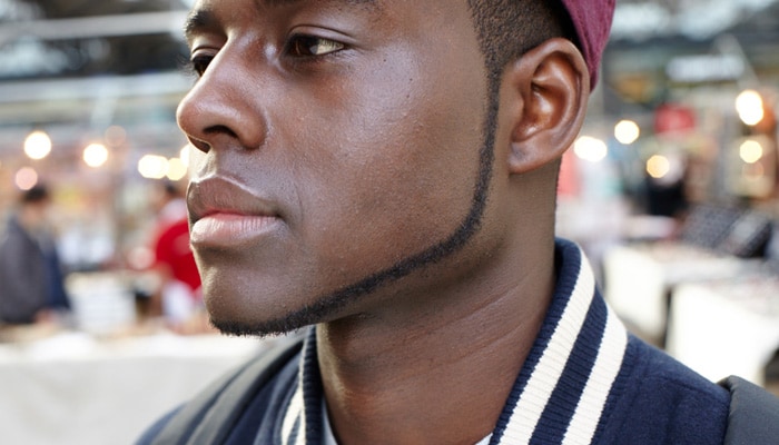 Side view of a man's face with accurately trimmed chin beard.