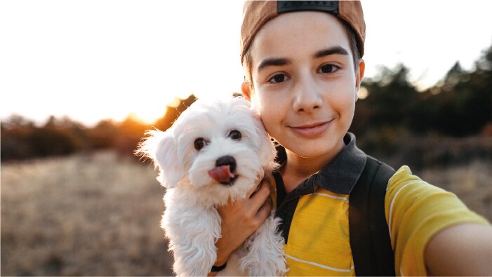 Kid taking picture with pet