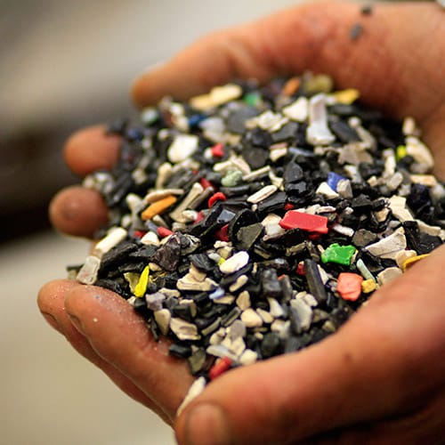 A close up of hands cupping broken pieces of material