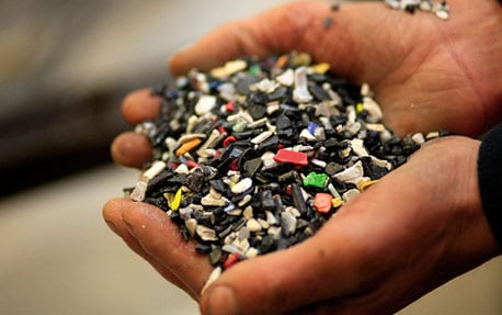 A close up of hands cupping broken pieces of material