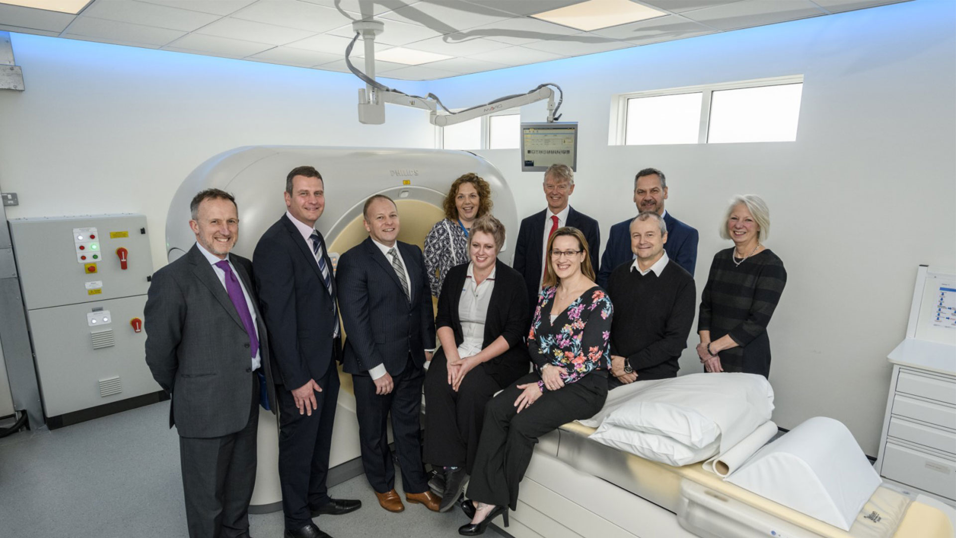 Download image (.jpg) Shown here, left to right, standing: Dr. Ian Francis, Consultant Radiologist; Derren Whitworth Project Manager and Barry Heathcote, Imaging Systems Account Manager, both of Philips UKI; Sheila Black, former Radiology Services Manager, StJohn Brown, Chairman, League of Friends; Steve Jenkins, Chief Executive, Queen Victoria Hospital; Gary Needle, Non Executive Director, Queen Victoria Hospital, (standing in front of Steve Jenkins), and Linda Skinner from the League of Friends. Seated in front on the left is Helen Joy, CT Superintendent Radiographer and on the left, Hannah Timbrell, CT Business Marketing Manager, Philips UKI  (opens in a new window)